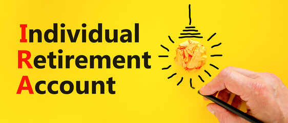 IRA individual retirement account symbol. Concept words IRA individual retirement account on a beautiful yellow background. Light bulb. Business IRA individual retirement account concept. Copy space