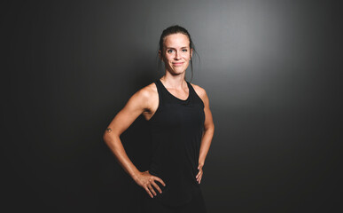 Naklejka premium Happy sports woman celebrating his success over black background