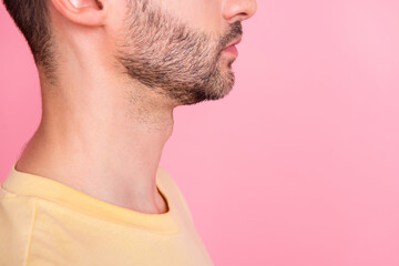 Obraz premium Side profile cropped photo of serious positive man stylish haircut yellow t-shirt look empty space isolated on pink color background