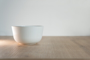 white cup on wooden table