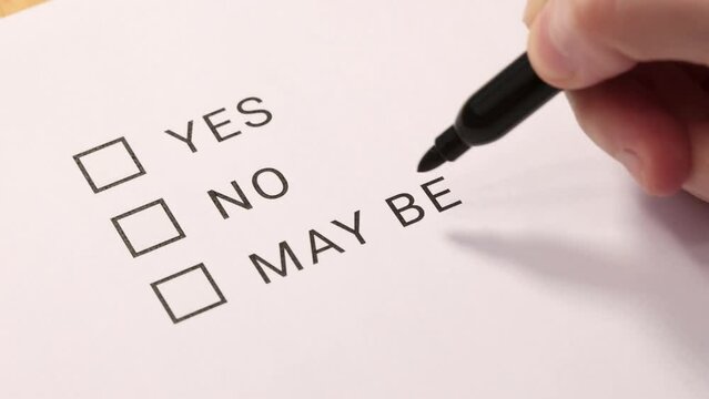 The person makes a choice of the item "No" in the questionnaire. Angle view. Selective focus.