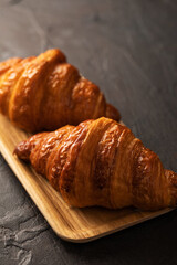 Croissants and coffee on dark background