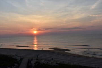 sunrise over the Atlantic ocean in Ocean City Md. on a beautiful morning with blue and red skies...