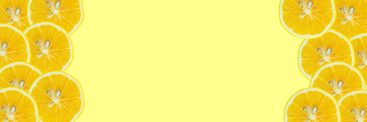 Lemon slices on color background with large copy space area