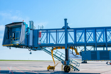 Jet bridge at the airport is brought to a large passenger plane