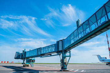 Jet bridge at the airport is brought to a large passenger plane