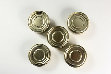 Many closed tin cans on white background. metal cans for fish and meat products