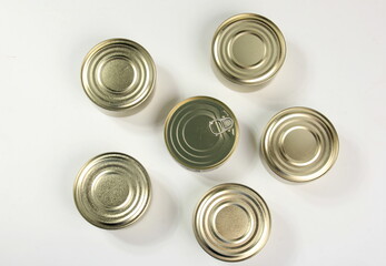 Many closed tin cans on white background. metal cans for fish and meat products