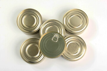 Many closed tin cans on white background. metal cans for fish and meat products