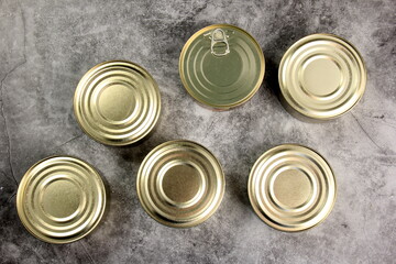 Tin cans on grey background, metal cans for fish and meat products