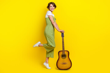Full length photo of cute young girl musician acoustic guitar hobby cheerful dressed stylish khaki...