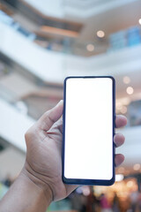 young man hand using smart phone with green screen against city buildings 