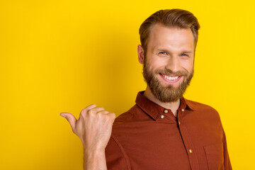 Portrait of cunning tricky funny man with masculine beard wear burgundy shirt indicating empty...