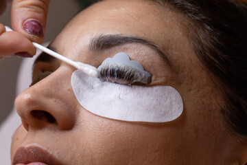 Closeup of a woman's face during an eyelash and eyebrow treatment