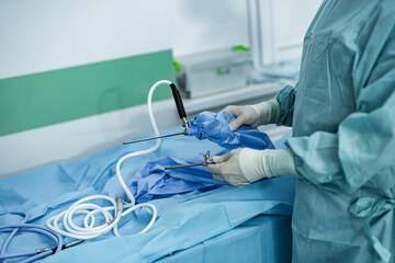 Operating specialist in uniform working with instruments. Surgery professional sterile uniform.