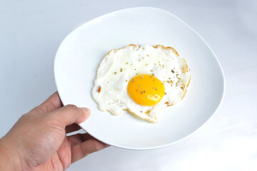 breakfast with delicious fried sunny side up egg on a white plate