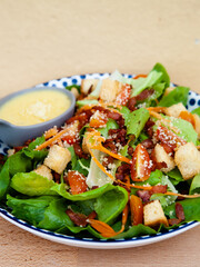 Fresh caesar salad with crispy bacon and crouton
