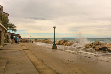 Rough waves and high water on the waterfront of Piran town in Slovenia in mid September
