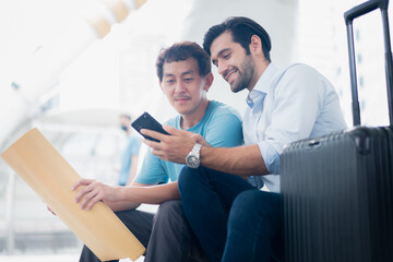 Fototapeta premium travel guide, Young man tourist with map . Couple of tourists consulting a city guide searching locations.
