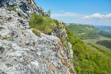 The remains of an ancient cave city. Ancient walls with entrance and openings.