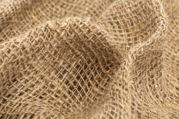 Burlap texture. Burlap fabric background with waves, folds and bruises