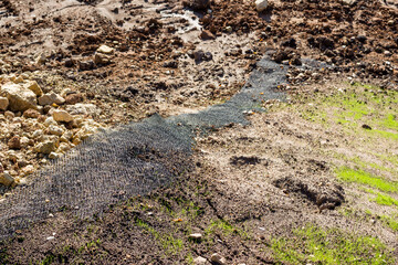 Fototapeta premium Strengthening the river bank with geogrid reinforcement