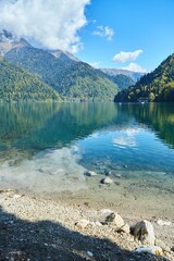 A beautiful clear lake surrounded by high mountains. Beautiful water landscape. Rest on the shore...