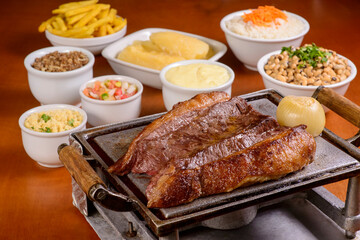 Brazilian Picanha. Barbecue steak roasted on the grill, served with traditional Brazilian dishes.