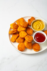 Close up of chicken nuggets on plate with sauce fastfood