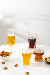 Glasses  light and dark beer fand snacks in bowl food and drink copy space
