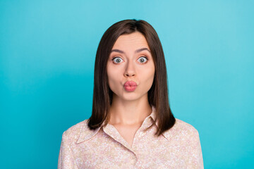 Fototapeta premium Close up photo of cute young woman send air kiss pouted lips dressed stylish smart casual clothes isolated on aquamarine color background