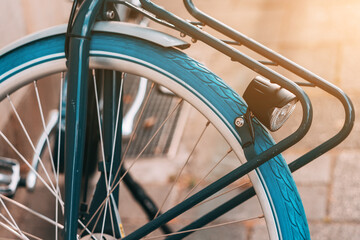 Detailed view of a retro vintage bicycle used for town transportation with blue tyre and iron trunk...