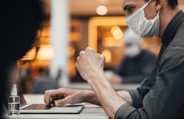 close up. freelancer in a protective mask works on a laptop