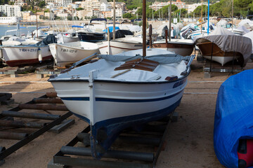 Fototapeta na wymiar Marina with small boats moored at the quay in Sant Feliu de Gixols, Catalonia, Spain