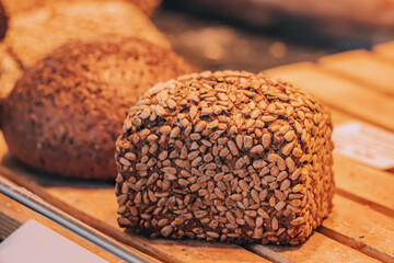 bakery products, delicious and fresh wheat bread with seeds on the shop window