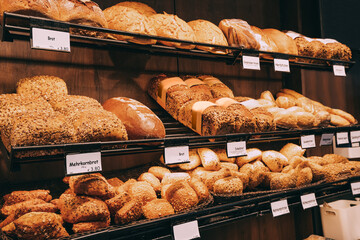 bakery products, delicious and fresh wheat bread and sweet rolls and buns on the shop window