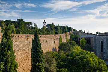 Fototapeta na wymiar Girona, Spain, 22 October 2022: Girona old City Walls Walkway on sunny summer day, known as Passeig de la Muralla. Old roman walls