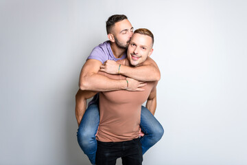 Fototapeta na wymiar Two young men couple over white background on studio