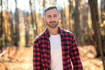 Young smiling man portrait in autumn park Outdoor