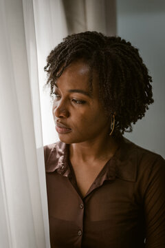 a black woman looking out the window