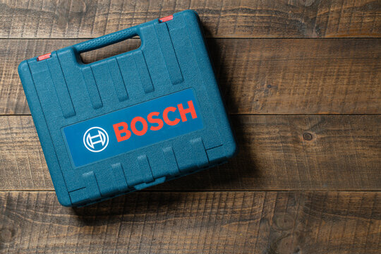 Kyiv, Ukraine - Sep, 21, 2022 : a tool case with a Bosch cordless drill in a plastic box on a wooden table . Electric screwdriver work tool Bosch, copy spase