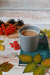 Autumn still life with a cup of coffee, autumn leaves, a book.