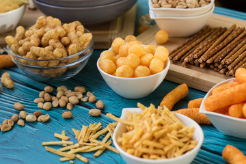 Beer salty snacks on wooden table