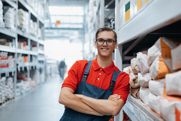 smiling supervisor standing next to a rack of plaster.