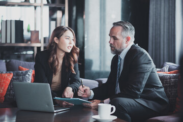 professional businesswoman discussing business with chief executive at office.Employees discuss earnings through computers.adults working happily at the office