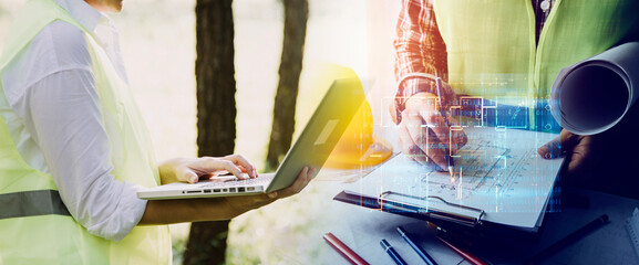 Obraz premium Construction engineer working at blueprint to build large commercial buildings in office. Engineering tools and construction concept.