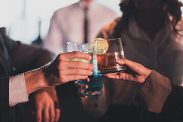 People celebrating a meeting sit and drink wine at a restaurant bar.Relaxing, drinking alcoholic beverages, have cocktails and beer.