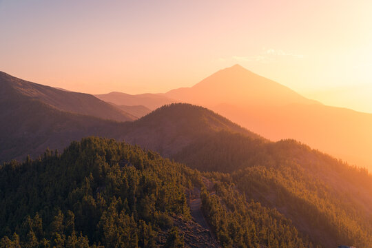 Mountain peak under sunset sky