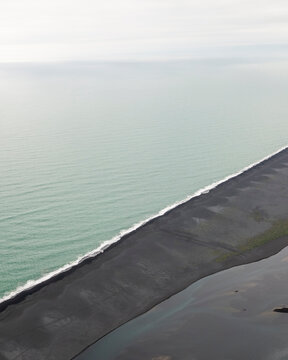 Aerial view of water formation along the coastline at river estuary in Iceland.