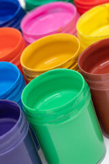 different cans of acrylic colors like red, blue and green for drawing, painting and art